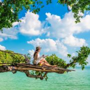 Digital nomad in Thailand on a tree overlooking ocean